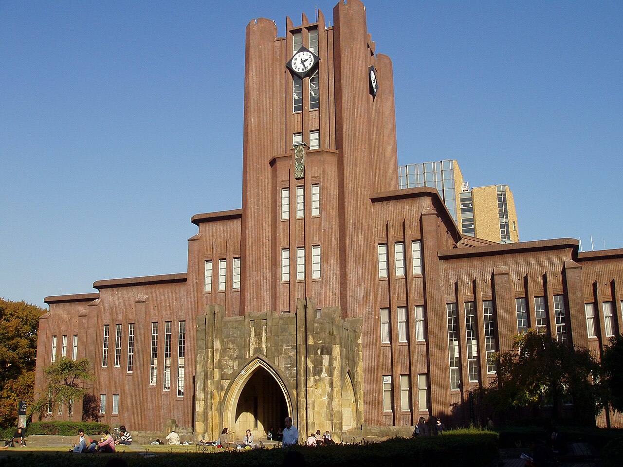 The Yasuda Auditorium at the University of Tokyo, a brick clock tower framed by trees