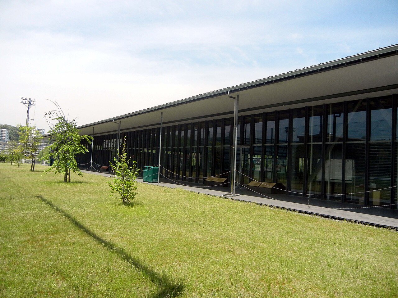 A student lounge on a Japanese university campus, with tables and chairs and large windows